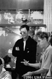 Director Wong Kar-wai discusses a scene with co-cinematographer Christopher Doyle on the set of the film.