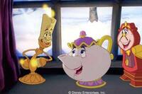 Lumiere, Mrs. Potts and Cogsworth watch with delight as relations between their master, Beast, and his reluctant guest, Belle, begin to thaw.