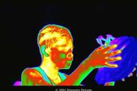 Thermal image of Luke holding his helmet in "The Human Body."