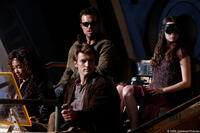Clockwise, the crew and passengers of "Serenity" prepare for a dangerous trip off ship: Adam Baldwin as Jayne, Summer Glau as River, Nathan Fillion as Captain Malcolm Reynolds and Gina Torres as Zoe.