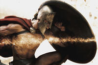 Stelios (Michael Fassbender) crouches behind his shield as shrapnel tears through the air in "300."