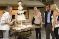 Jane (Katherine Heigl, center), and engaged couple George (Edward Burns) and Tess (Malin Akerman), marvel at the creation of master baker Antoine (Ronald Guttman) in "27 Dresses."