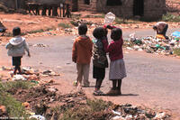 Children play with an empty water bottle in "The End of Poverty?"