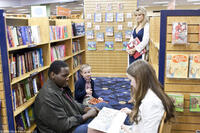 Quinton Aaron as Michael Oher, Jae Head as S.J., Sandra Bullock as Leigh Anne Tuohy and Lily Collins as Collins in "The Blind Side."