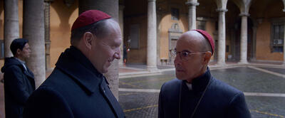 'Conclave' Is In Theaters Now: Watch An Exlcusive Clip with Ralph Fiennes and Stanley Tucci