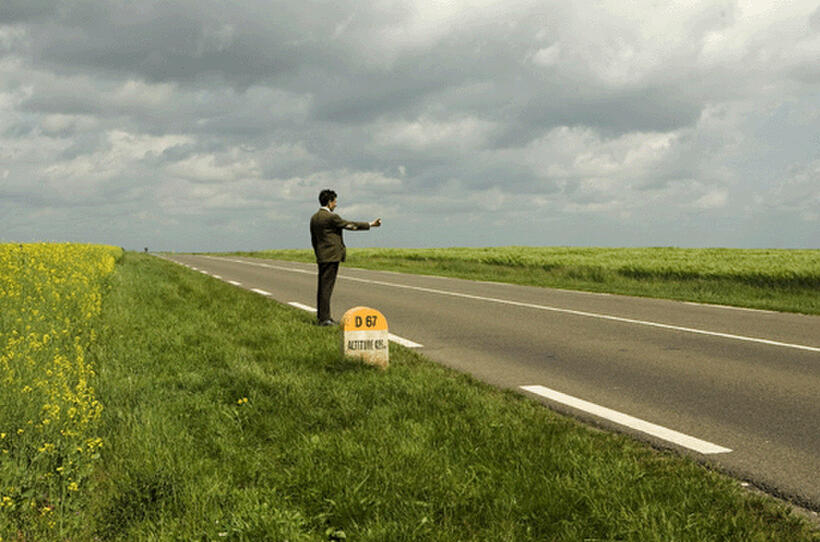 Rowan Atkinson as Mr. Bean attempts to hitchhike in "Mr. Bean's Holiday."