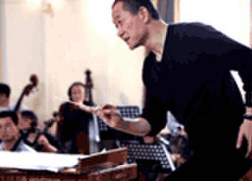 Tan Dun conducts a rehearsal of The First Emperor at an opera workshop in Shanghai in April 2006.
