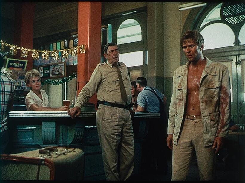 Chips Rafferty as Jock Crawford and Gary Bond as John Grant in "Wake in Fright."