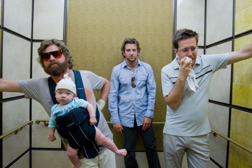 Zach Galifianakis as Alan holds Baby Tyler, Bradley Cooper as Phil and Ed Helms as Stu in "Hangover."