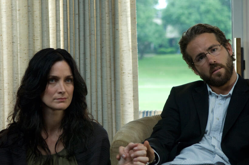Carrie-Anne Moss and Ryan Reynolds in "Fireflies in the Garden."