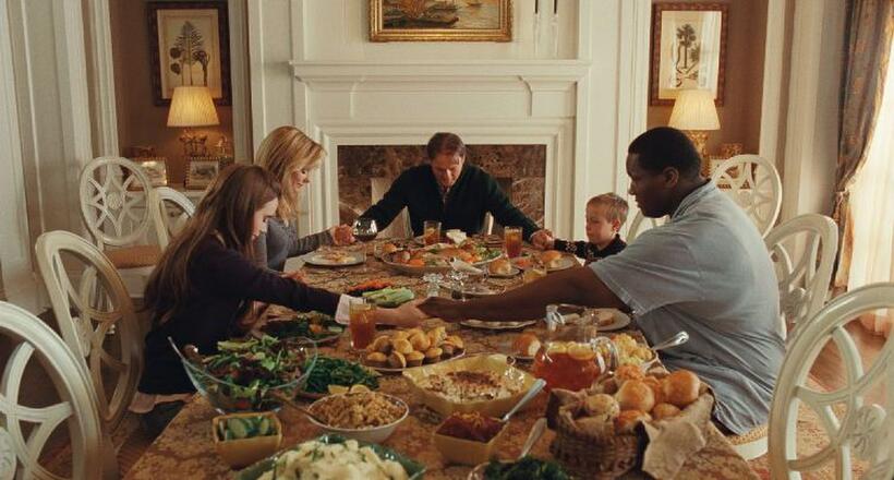 Lily Collins as Collins, Sandra Bullock as Leigh Anne Tuohy, Tim McGraw as Sean Tuohy, Jae Head as S.J. and Quinton Aaron as Michael Oher in "The Blind Side."