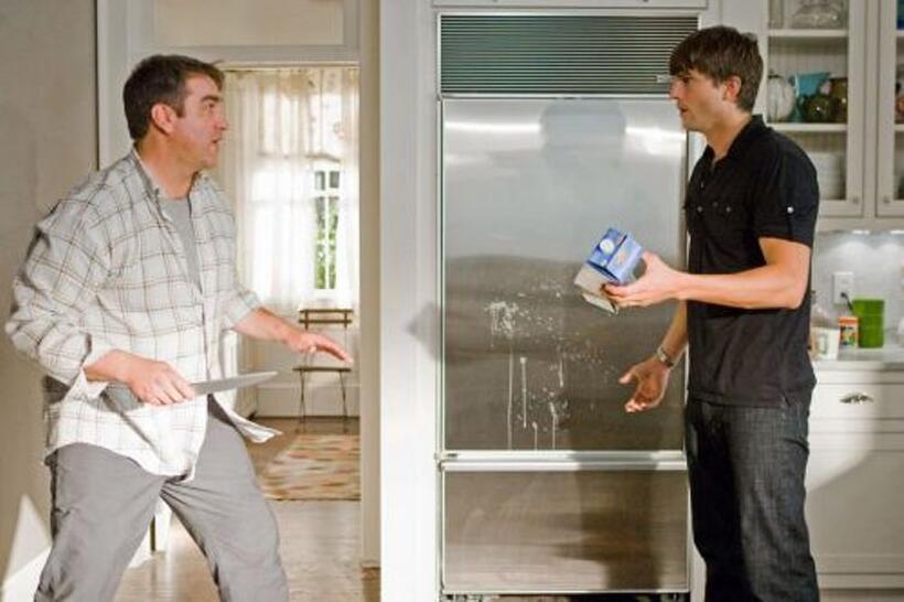Rob Riggle as Henry and Ashton Kutcher as Spencer in "Killers."