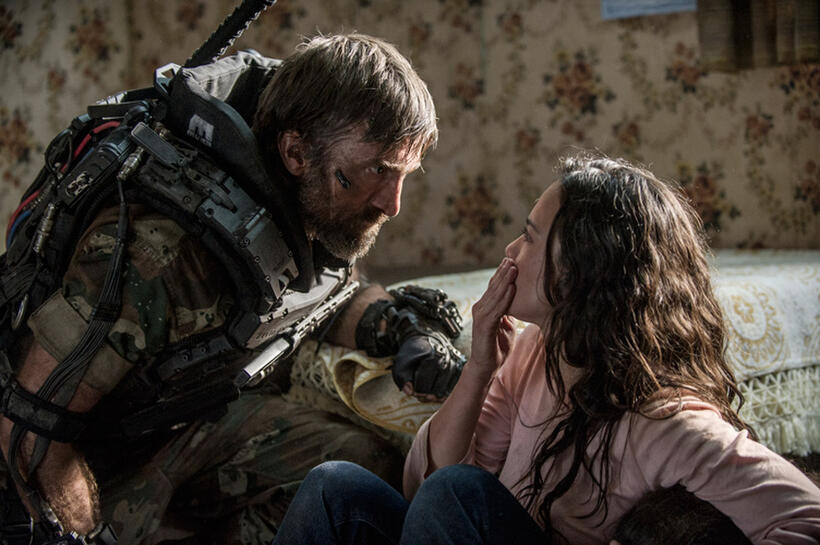 Sharlto Copley as Kruger and Alice Braga as Frey in "Elysium."