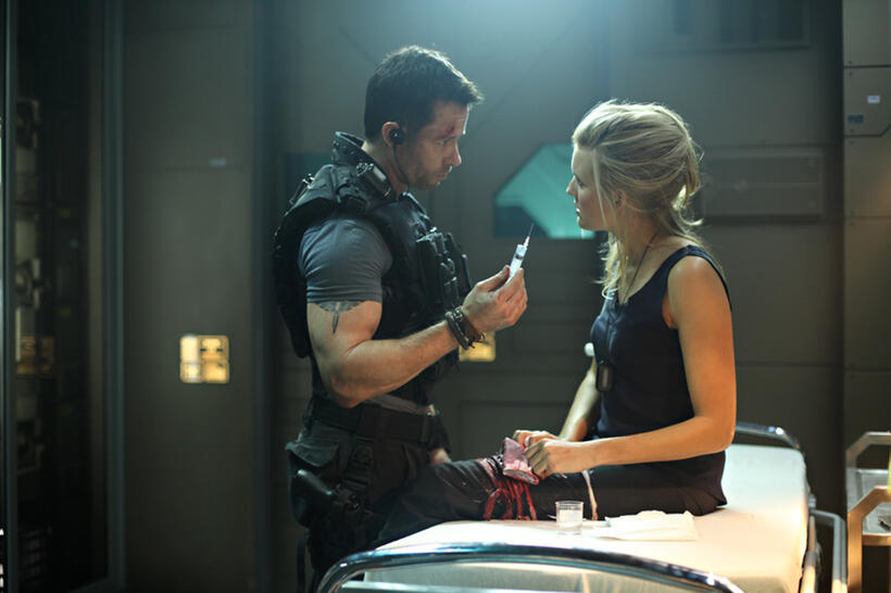 Guy Pearce as Snow and Maggie Grace as Emilie Warnock in "Lockout."