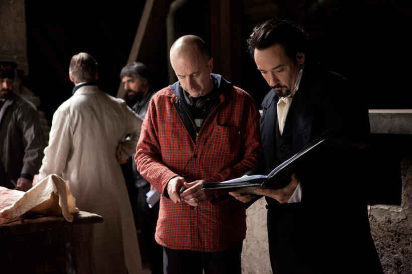 Director James McTeigue and John Cusack on the set of "The Raven."