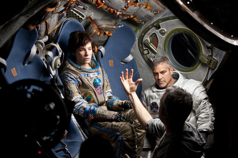 Sandra Bullock, George Clooney and Director Alfonso Cuaron on the set of "Gravity."
