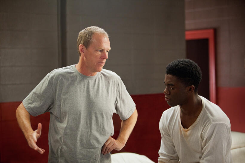 Director Brian Helgeland and Chadwick Boseman on the set of "42."