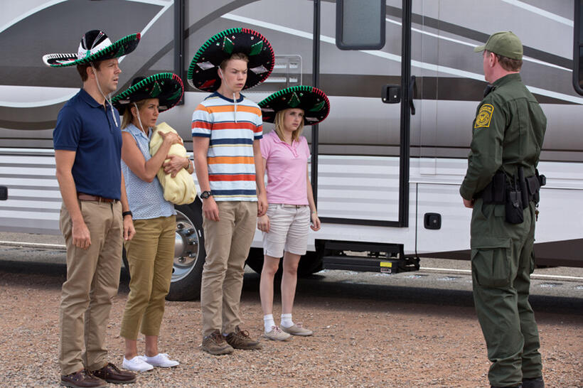 Jason Sudeikis as David Clark, Jennifer Aniston as Rose O'Reilly, Will Poulter as Kenny Rossmore, Emma Roberts as Casey Mathis and Kevin Dorff as Border Guard in "We're the Millers."