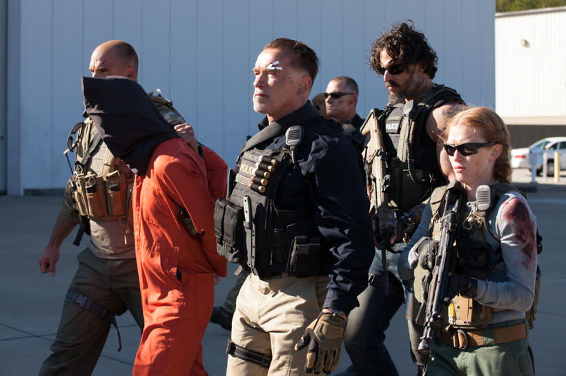 Arnold Schwarzenegger as Breacher, Joe Manganiello as Grinder and Mireille Enos as Lizzy in "Sabotage."