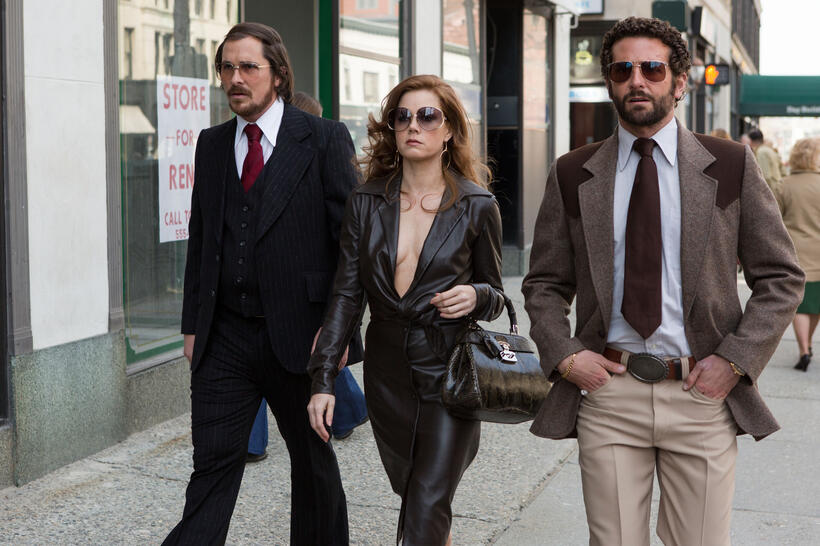 Christian Bale as Irving Rosenfeld, Amy Adams as Sydney Prosser and Bradley Cooper as Richie Dimaso in "American Hustle."