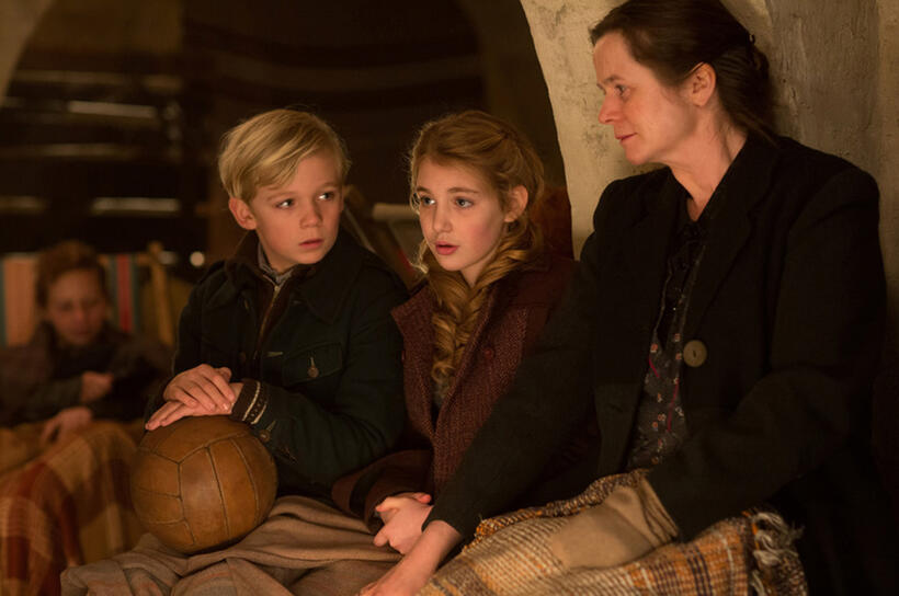 Nico Liersch as Rudy, Sophie Nelisse as Liesel and Emily Watson as Rosa in "The Book Thief."