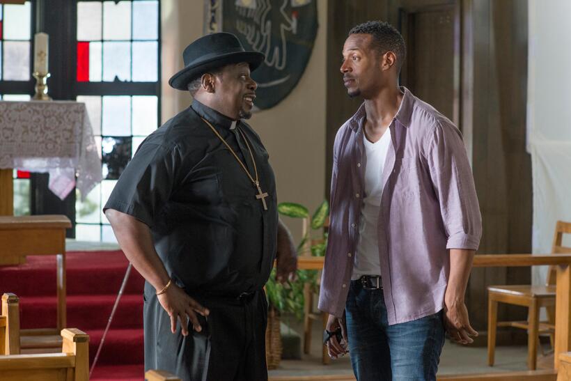 Cedric the Entertainer as Father Williams and Marlon Wayans as Malcolm in "A Haunted House 2."