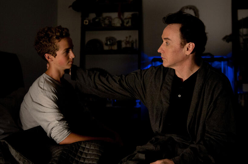 Evan Bird as Benjie Weiss and John Cusack as Stafford Weiss in "Maps to the Stars."