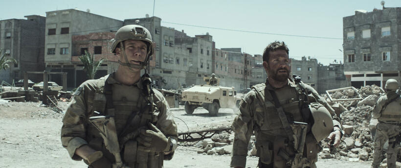 Jake Mcdorman as Biggles and Bradley Cooper as Chris Kyle in "American Sniper."