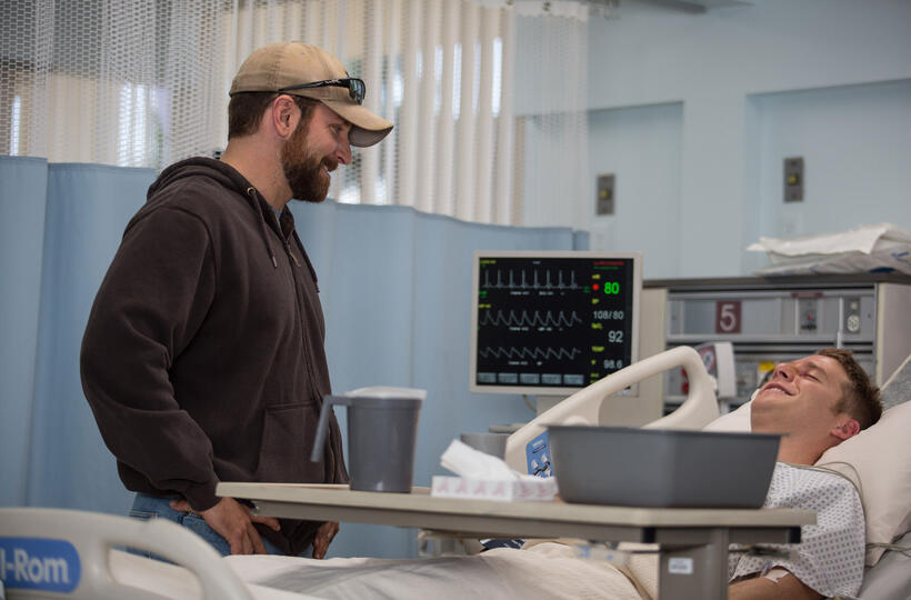 Bradley Cooper as Chris Kyle and Jake Mcdorman as Biggles in "American Sniper."