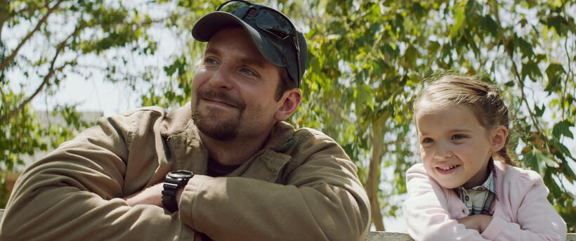 Bradley Cooper as Chris Kyle and Madeleine Mcgraw as Mckenna in "American Sniper."