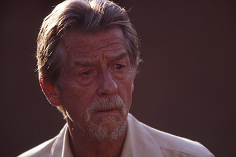 John Hurt as Christopher, a Catholic priest, in "Beyond the Gates."