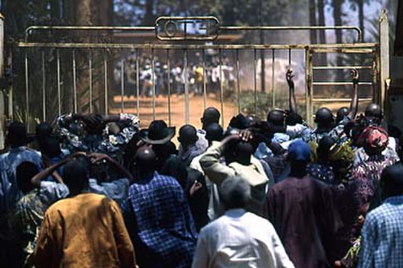 Refugees watch as extreme militias brandish machetes and taunt them in "Beyond the Gates."