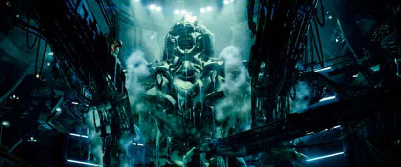 The alien Megatron is frozen in a holding hangar in "Transformers."