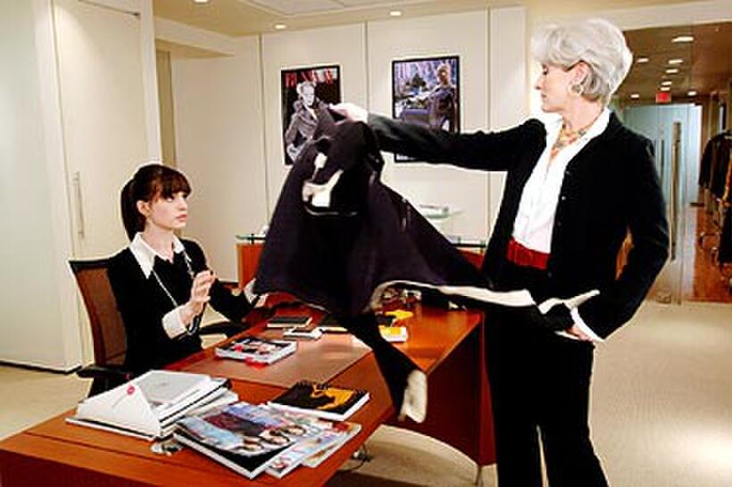 Fashion magazine editor Miranda Priestly (Meryl Streep) dumps her coat on Andy Sachs's (Anne Hathaway) desk in "The Devil Wears Prada."