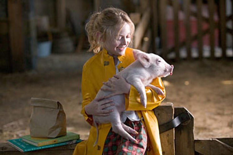 Fern (Dakota Fanning) gives Wilbur a pig hug in "Charlotte's Web."