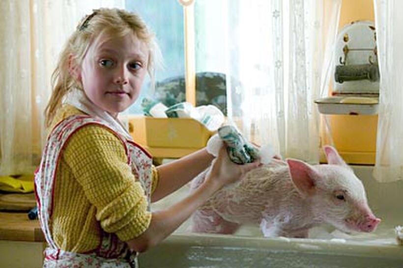 Fern (Dakota Fanning) keeps Wilbur clean in "Charlotte's Web."
