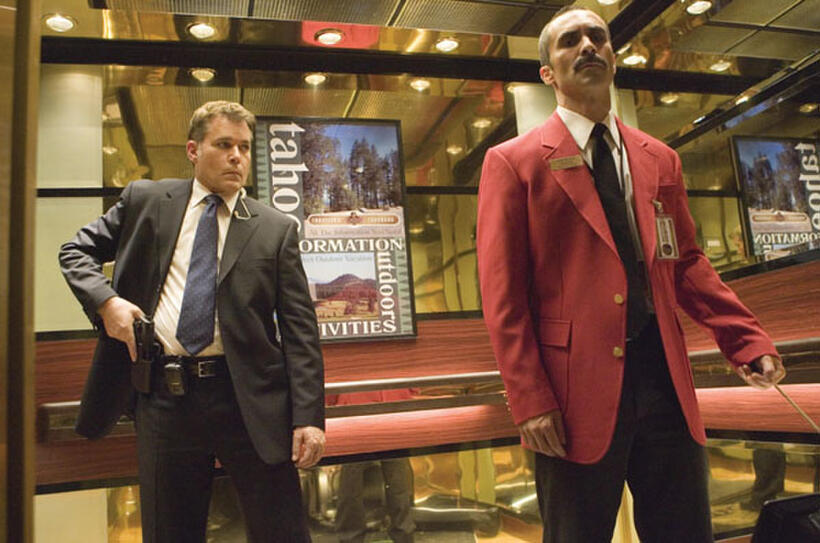 FBI Agent Donald Carruthers (Ray Liotta) readies his weapon against assassin Pasquale Acosta "S.A. Gerald Diego" (Nestor Carbonell) in "Smokin' Aces."