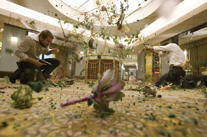 Agent Richard Messner (Ryan Reynolds) and Agent Baker (Brian Bloom) dodge a spray of bullets in "Smokin' Aces."