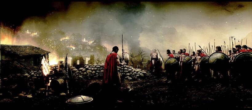 King Leonaidas (Gerard Butler) looks through the remains of a devastated Greek village, scanning the details of the destruction in "300."