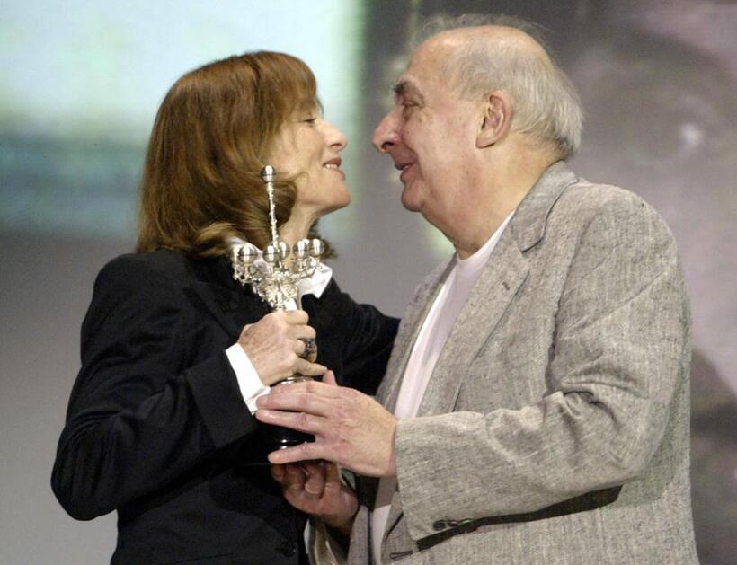 Claude Chabrol as he gives the award to Isabelle Huppert at the 56th Berlin International Film Festival.