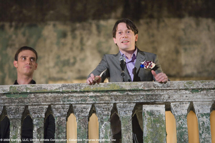 Flanked by Elvis (Anatole Taubman), Dominic Greene (Mathieu Amalric) makes his welcome speech to party guests in "Quantum Solace."