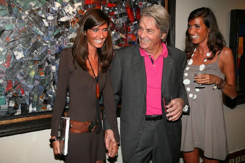 Alain Delon and his guests at the pre-launch cocktail party for his upcoming auction of paintings.