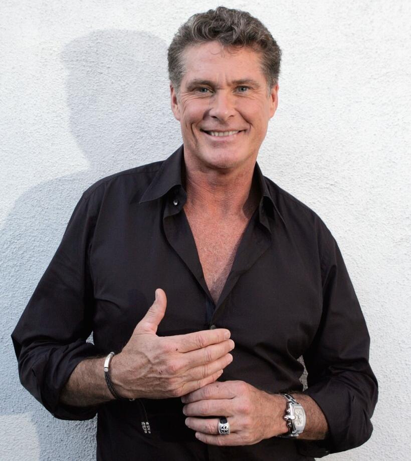 David Hasselhoff poses for a photograph before signing copies of his new book "Don't Hassle the Hoff".