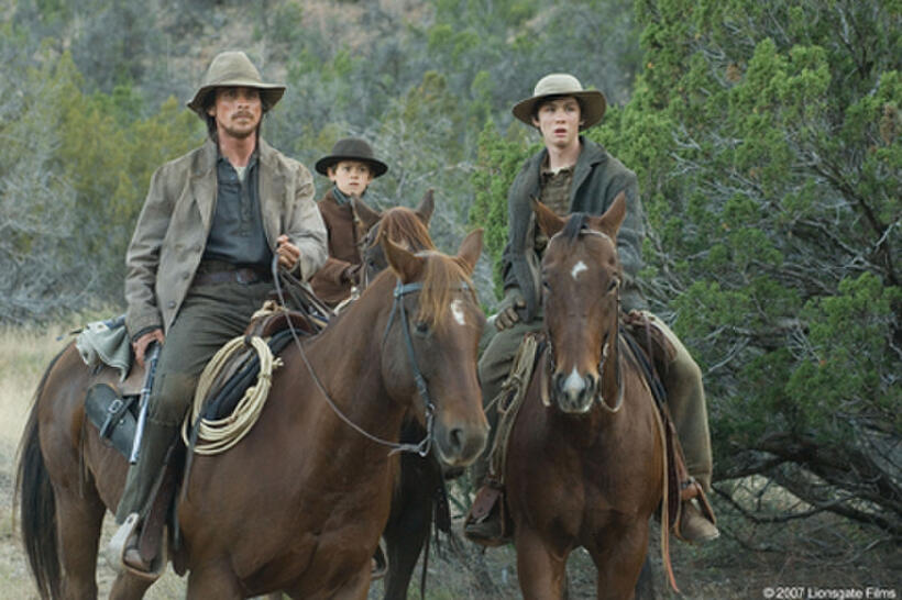 Dan Evans (Christian Bale) and his sons Mark Evans (Ben Petry) and William Evans (Logan Lerman) in "3:10 to Yuma."