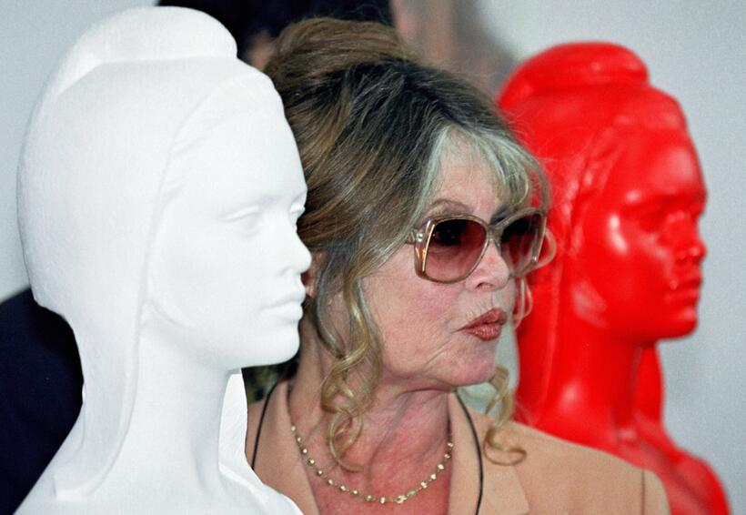 Brigitte Bardot next to the Bust of Marianne the symbol of the French Republic.