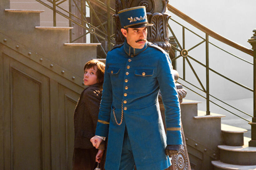 Asa Butterfield as Hugo Cabret and Sacha Baron Cohen as Station inspector in "Hugo.''