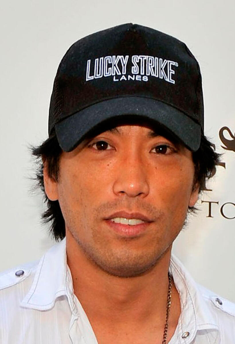 Peter Shinkoda at the "Goodbye cellulite, hello bikini" poolside party in California.