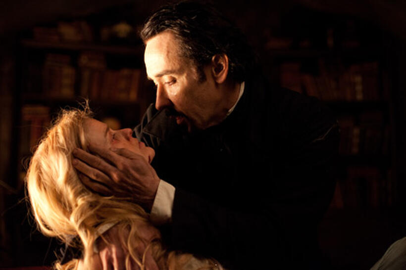 Alice Eve as Emily Hamilton and John Cusack as Edgar Allan Poe in ``The Raven.''