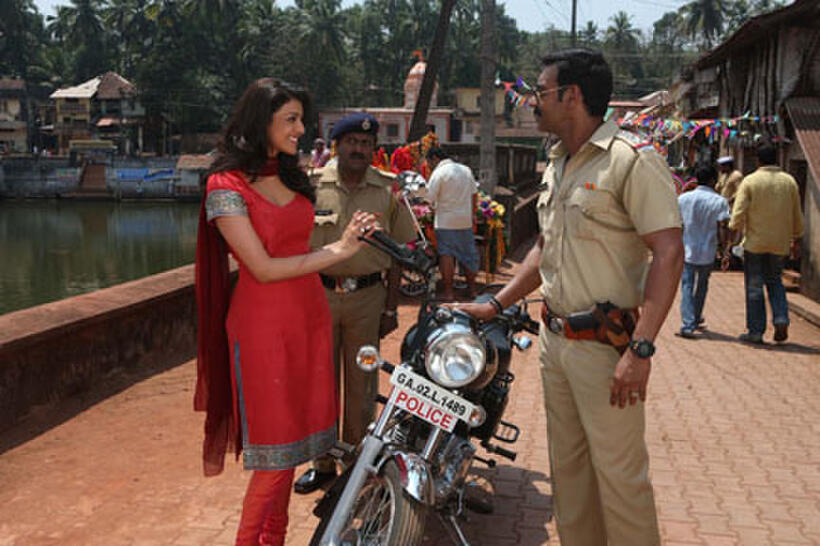 Kajal Agarwal as Kaavya Bhosle and Ajay Devgan as Baji rao singham in ``Singham.''