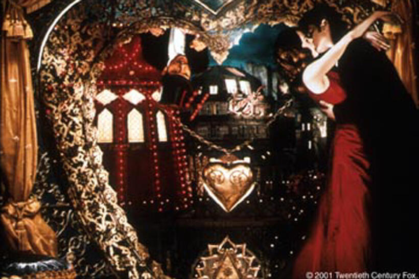 Satine (Kidman), "The Sparkling Diamond" confuses Christian (McGregor), a poor young poet enlisted by Toulouse-Lautrec (Leguizamo, upper left) to write a new musical production for the Moulin Rouge.